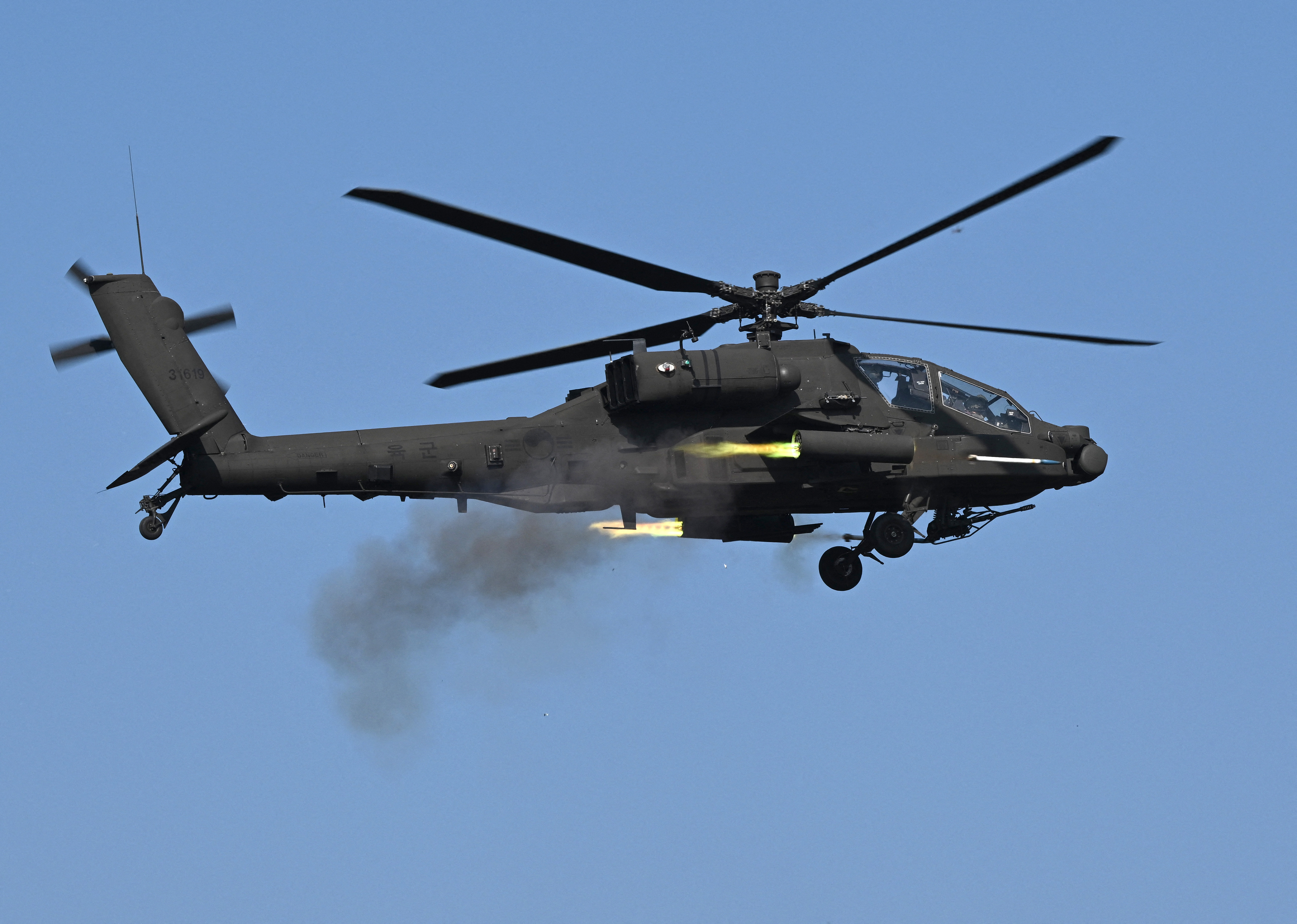 Un hélicoptère Apache AH-64 sud-coréen tire des roquettes lors d'un exercice combiné de tir réel entre les armées sud-coréenne et américaine au complexe de tir réel Rodriguez à Pocheon le 30 octobre 2024. (Photo de Jung Yeon-je / AFP) (Photo de JUNG YEON-JE/AFP via Getty Images)
