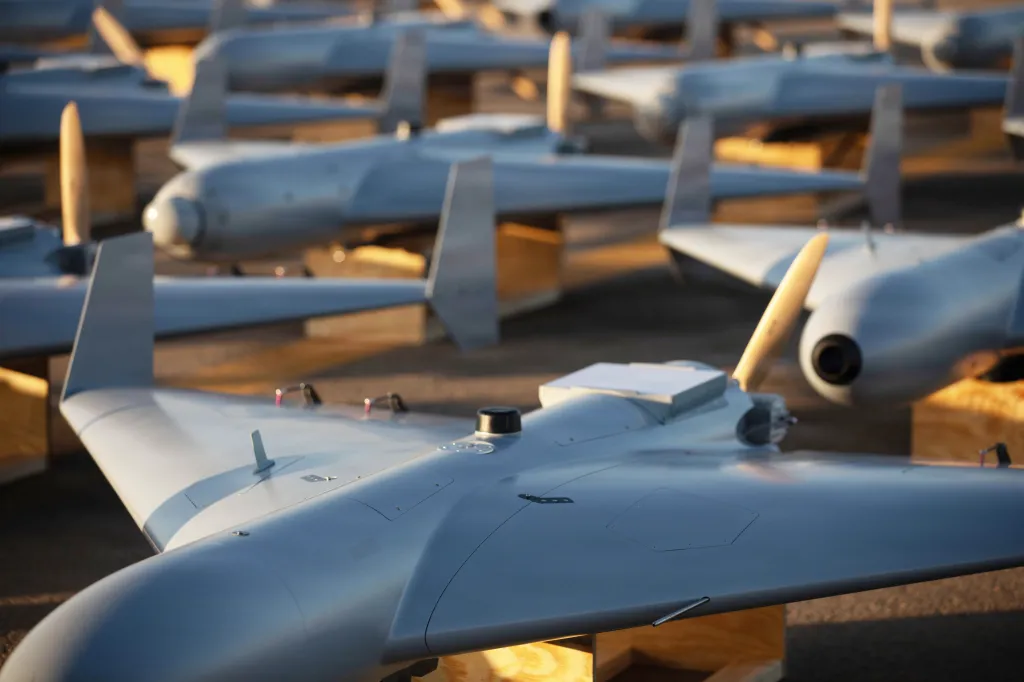 ZONE DE RESPONSABILITÉ DU COMMANDEMENT CENTRAL DES ÉTATS-UNIS (23 novembre 2025) des drones du système d'attaque de combat sans pilote (LUCAS) à faible coût sont positionnés sur le tarmac d'une base dans la zone opérationnelle du Commandement central des États-Unis (CENTCOM), le 23 novembre. Les plates-formes LUCAS font partie d'un escadron de drones d'attaque à sens unique CENTCOM récemment déployé au Moyen-Orient pour renforcer la sécurité et la dissuasion régionales. (Photo de courtoisie)